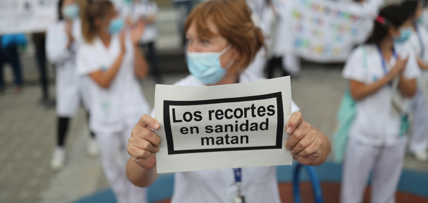 Sanitaria con un cartel que dice: Los recortes en sanidad matan