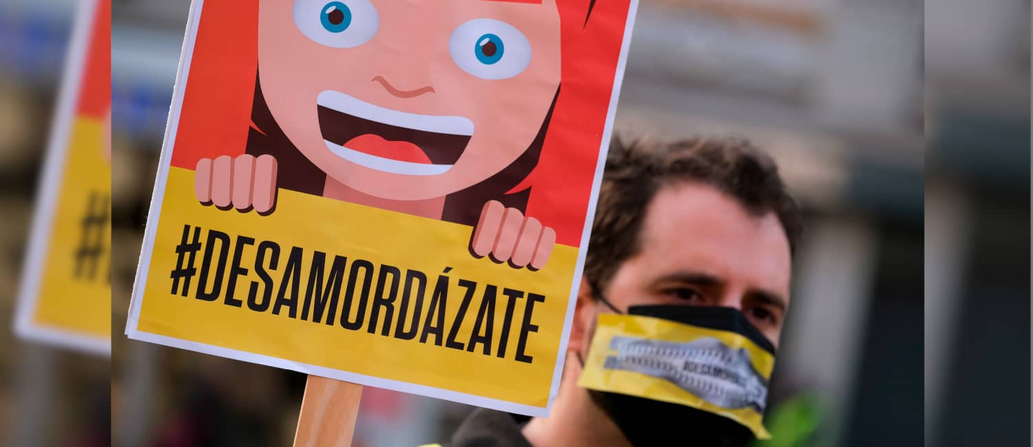 Manifestánte con un cartel que pone #desamordázate