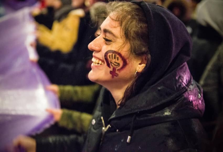 Una mujer baila y sonríe durante el 8M